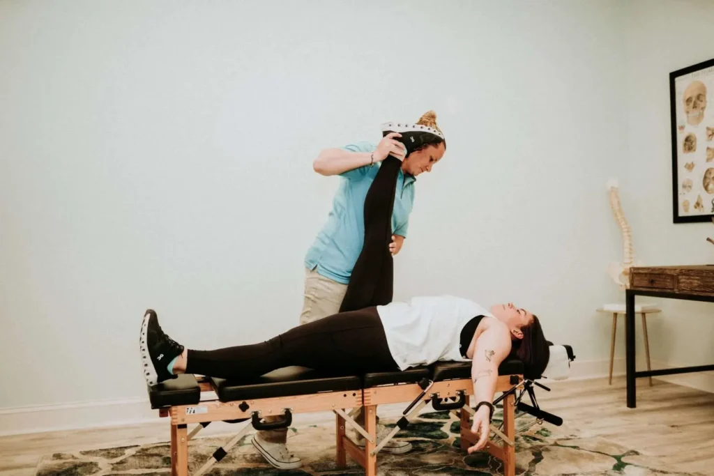 Dr Jordan Walsh applying chiropractic techniques to patient