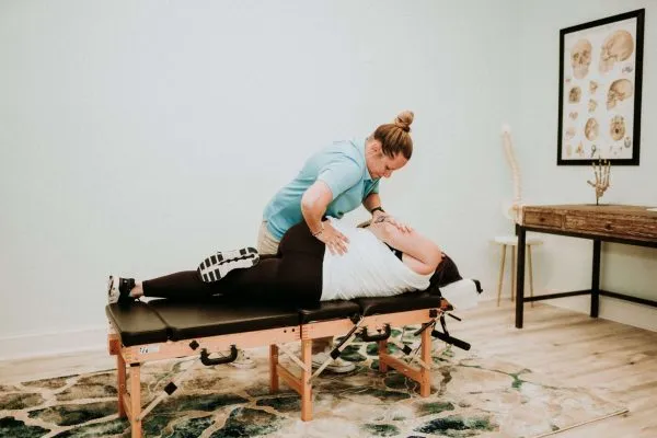 Dr Jordan Walsh applying chiropractic techniques to patient