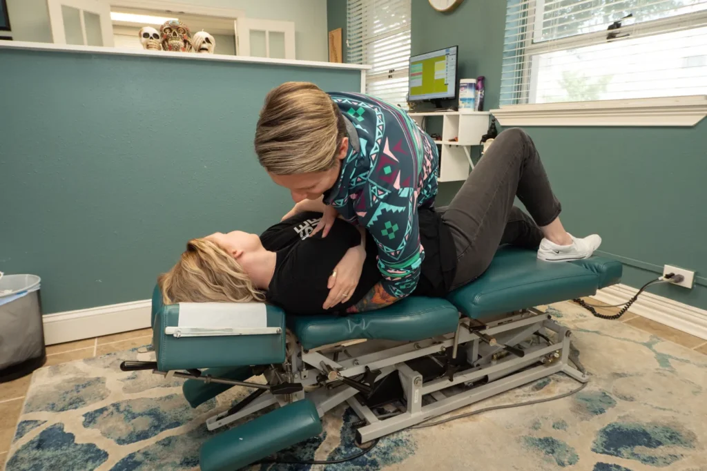 Dr Jordan Walsh working with a female - adjusting spine