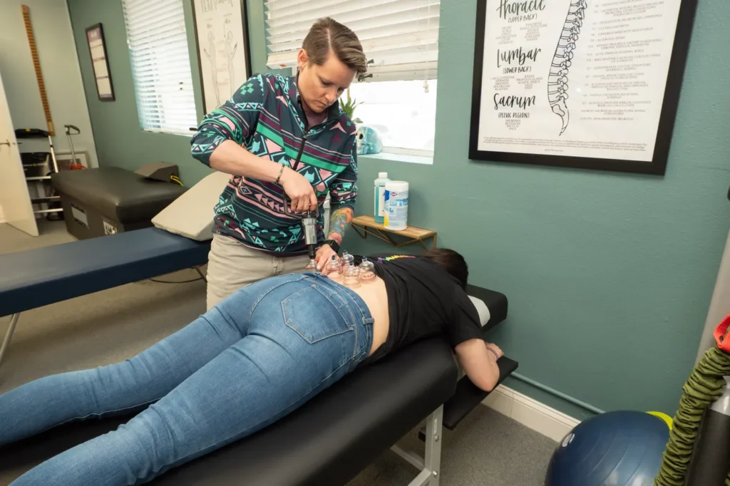 Dr Jordan Walsh utilizing cupping on a patient back